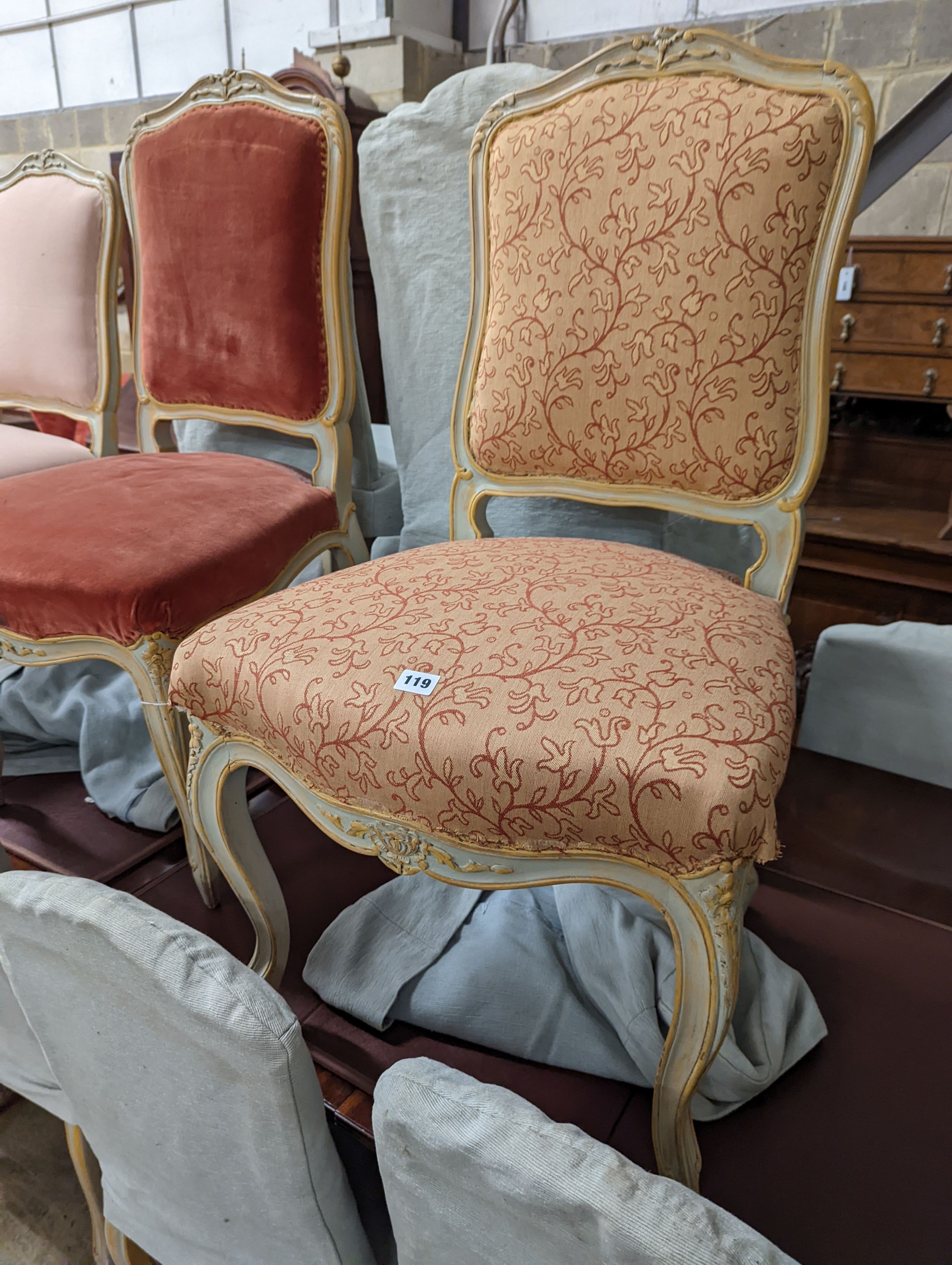 A set of fourteen French Louis XV style painted upholstered dining chairs with loose covers